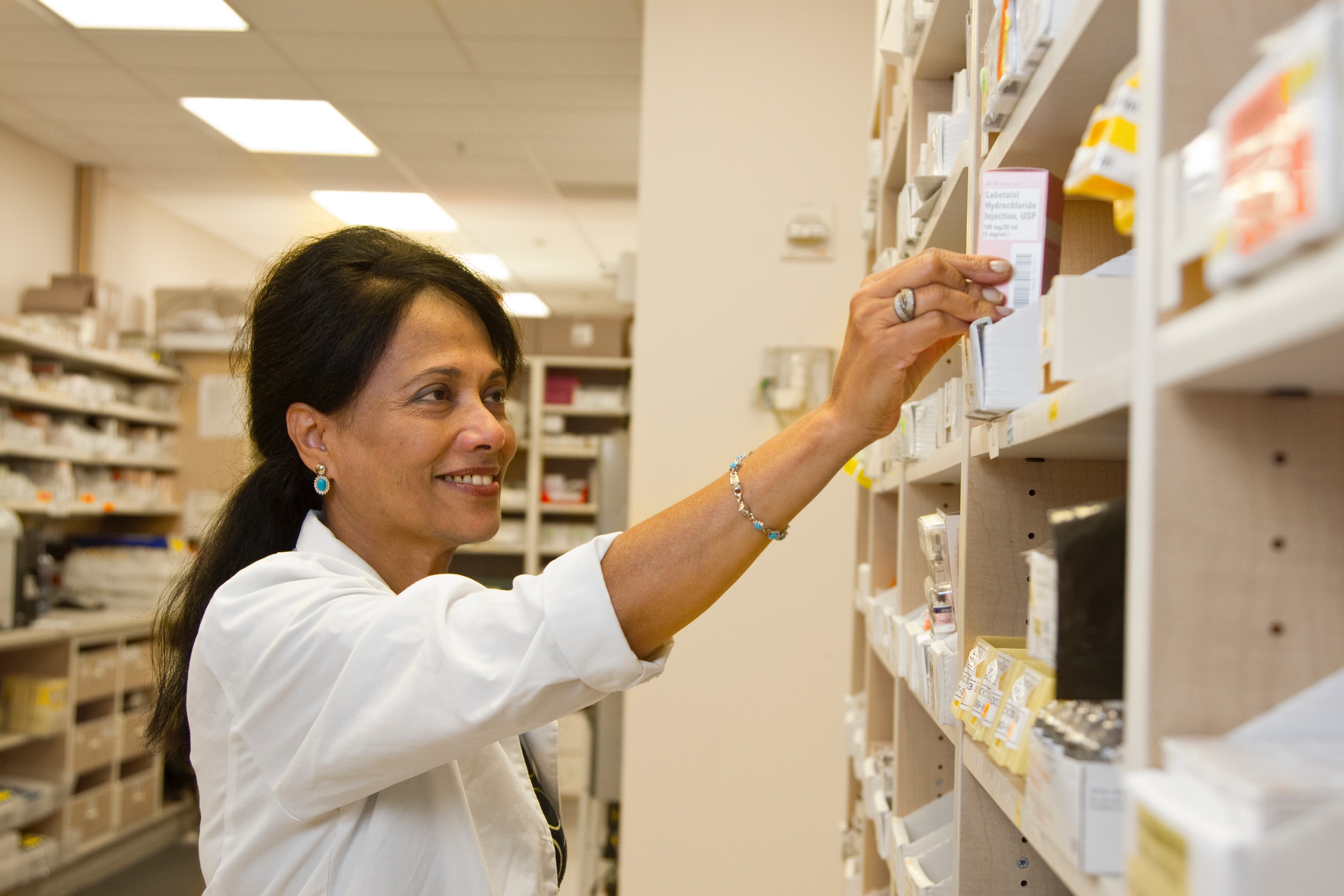 Inhouse Pharmacy: A Legit Online Pharmacy Misrepresented by Daily Post Vanuatu 1 A pharmacist in one of the legit online pharmacies pulls a dispensing box of medication from a shelf.
