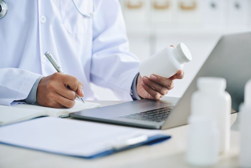 Pharmaceutical Regulations for Legal Online Pharmacies 2 A doctor prescribing medication while complying with pharmaceutical regulations and laws