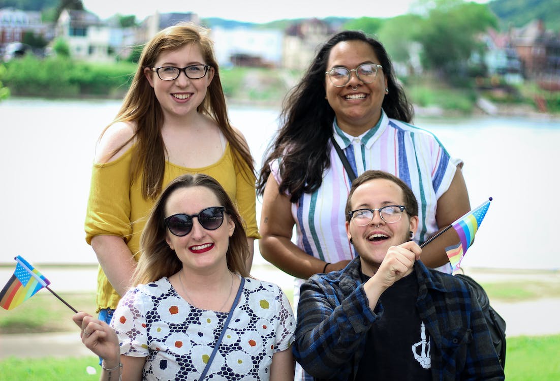Guide to Gender-Affirming Health Care and HRT 1 People posing for a photo with rainbow flags