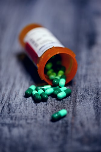 Capsules spilling out from prescription bottle